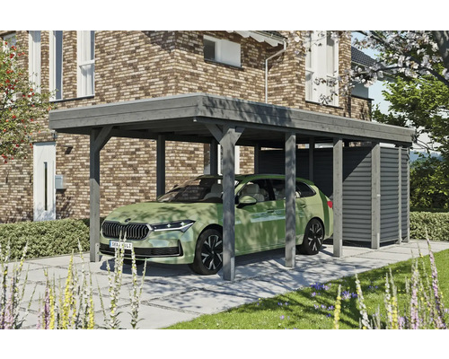 Prístrešok na auto SKAN HOLZ Friesland-Hybrid vr. hliníkového úložného priestoru, 314 x 708 cm bridlice Drevený prístrešok pre auto s úložným priestorom vedľa domu s tehlovými múrmi a zeleným autom