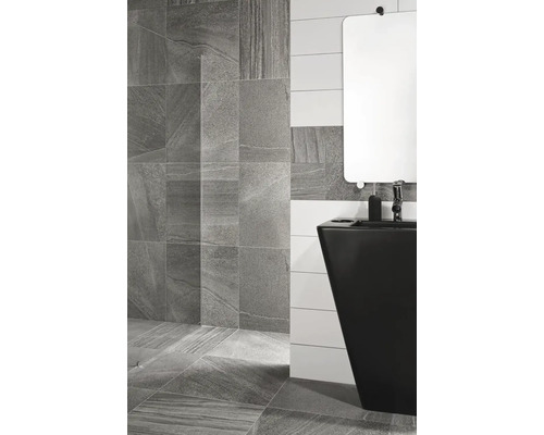 Kúpeľňa so sivou dlažbou na podlahe a stene a čiernym umývadlom