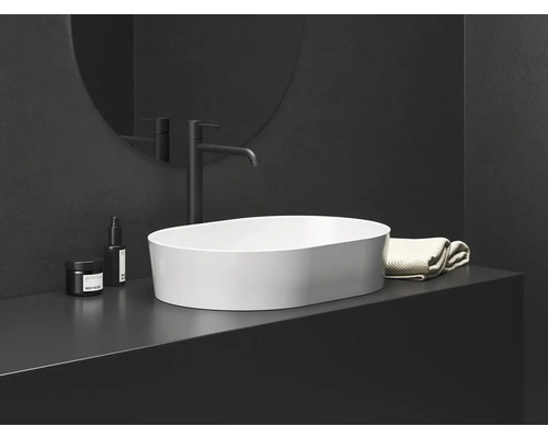 Scéna kúpeľne s umývadlom na dosku, batériou a uterákom