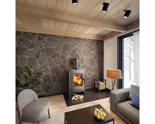 Obývacia izba s krbovými kachľami, stenou s kamenným dekorom a dreveným stropom