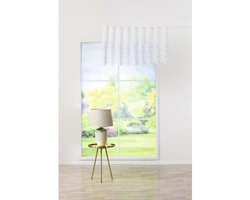 Dekorácia okna s bielym krátkym závesom a lampou na odkladacom stolíku