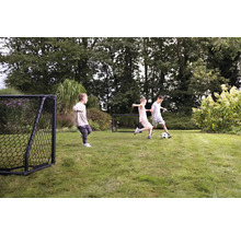 Scéna v záhrade s hrajúcimi sa deťmi, futbalom a futbalovými bránkami