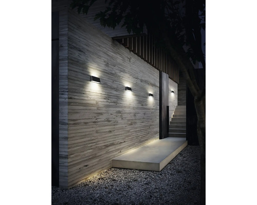 Moderná vonkajšia stena s osvetlením, schodiskom a štrkovou cestou