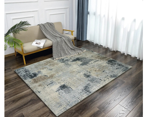 Obývacia izba s pohovkou a abstraktným kobercom na drevenej podlahe