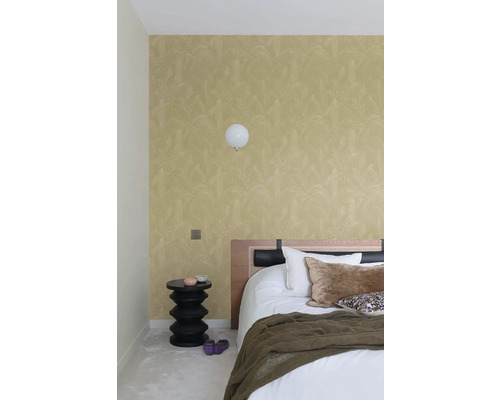 Spálňa s vzorovanou tapetou, nočným stolíkom a posteľou