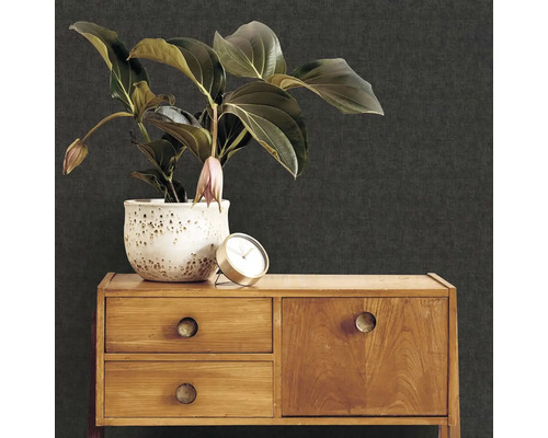 Dekoratívna scéna s hrnkovou rastlinou, hodinami a drevenou komodou pred tapetou