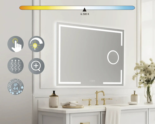 "Osvetlené zrkadlo nad umývadlom so zlatou armatúrou a dekoráciou