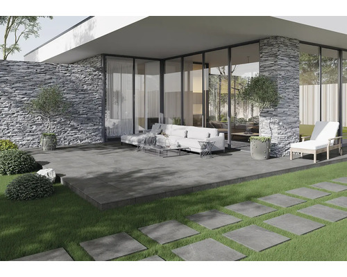 Exteriér so sivými terasovými dlaždicami, sedením a kamennou stenou