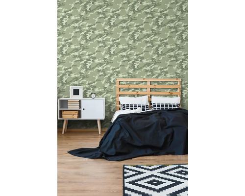 Spálňa s maskovacou tapetou, posteľou, nočným stolíkom a kobercom