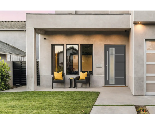 Moderná fasáda domu s vchodovými dverami, oknami a posedením na terase