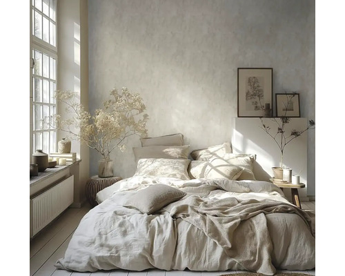 Svetlá spálňa s posteľou, vankúšmi, dekou, obrazmi a dekoráciami