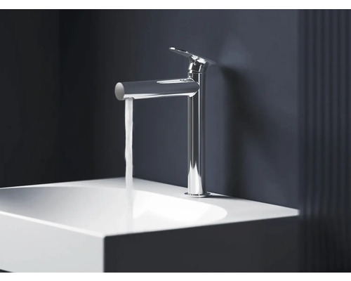 Lesklá chrómová umývadlová batéria s tečúcou vodou nad bielym umývadlom