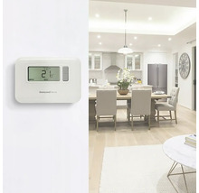 Izbová scéna s elektronickým termostatom na reguláciu teploty a logom Honeywell Home.