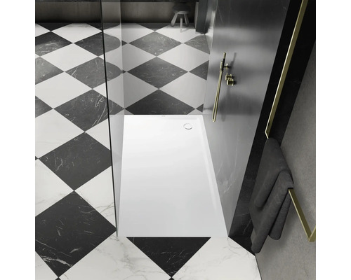 Kúpeľňa so štvorcovými dlaždicami, sprchou a uterákom