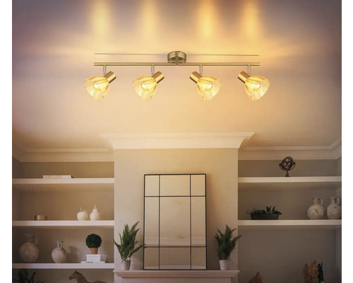 Stropné svietidlo so štyrmi reflektormi a sklenenými tienidlami namontované na strope obývacej izby.