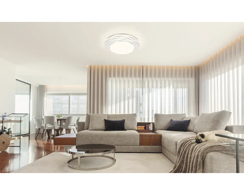 Svetlá obývacia izba s pohovkou, stolom a stropným svietidlom