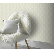 Dekoratívny obklad stien s geometrickou tapetou za stoličkou s vankúšmi a dekoráciou