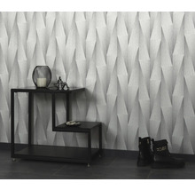 Pohľad do miestnosti s tapetou so vzorom, dekoráciami na príručnom stolíku a topánkami