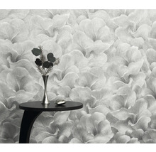 Detailný záber kvetinovej tapety s malým stolom a vázou