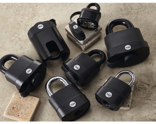 Rôzne čierne visiace zámky Yale na rovnom povrchu.