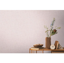 Dekoratívne zátišie s vázou, kvetmi a knihami pred vzorovanou tapetou