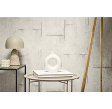 Dekoratívne interiérové vybavenie s tapetou v betónovom vzhľade, stolnou lampou a vázou