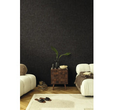 Obývacia izba s tmavou tapetou, nočným stolíkom a sedacím nábytkom pre útulnú atmosféru.