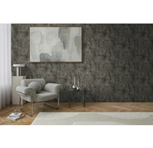 Obývacia izba s kreslom, stolom a dekoráciou pred štruktúrovanou stenou