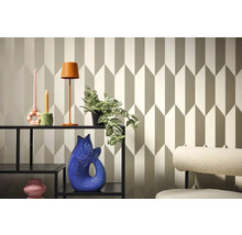 Dekoratívna izba s geometrickou tapetou, regálom, lampou a dekoratívnymi predmetmi