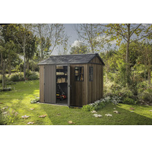 Záhradná scéna s dreveným záhradným domčekom s čiastočne otvorenými posuvnými dverami a oknom