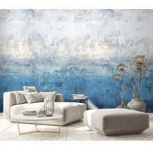 Obývacia izba so vzorovanou tapetou, pohovkou, stoličkou, stolom a dekoráciou