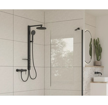 Moderná kúpeľňa s čiernou sprchovou armatúrou a sklenenou stenou.