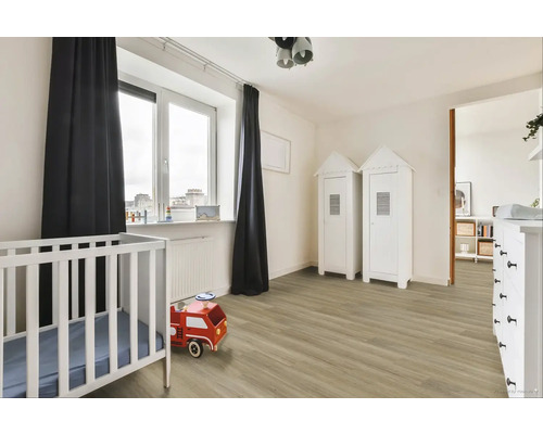 Svetlá detská izba s detskou postieľkou, hračkou hasičského auta a dvoma skriňami v štýle plážového domu