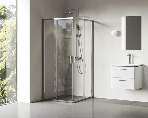 Rohová sprcha so sprchovou batériou a umývadlo so zrkadlom v kúpeľni