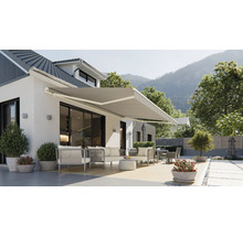 Fasáda domu s vysunutou markízou a záhradným nábytkom na terase.