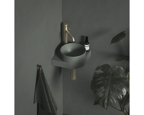 Moderná kúpeľňa s umývadlom na dosku, batériou, uterákom a izbovou rastlinou