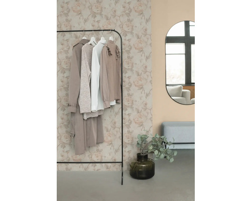 Stojan na oblečenie s oblečením, zrkadlom a dekoráciou v miestnosti.