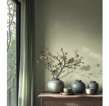 Dekoratívne vázy a misky na drevenej skrinke vedľa okna