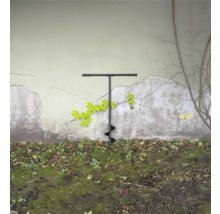 Zemný vrták v záhrade pred stenou