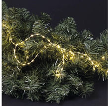 Dekoratívna jedľová vetva s teplou bielou svetelnou reťazou