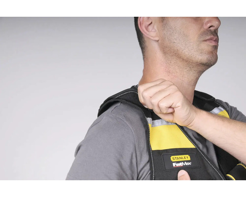 Muž má na sebe pracovnú vestu Stanley FatMax