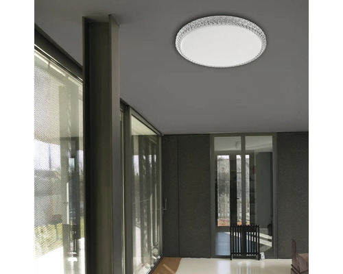 Pohľad na izbu s okrúhlym stropným svietidlom s krištáľovým okrajom