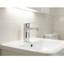 Umývadlo s batériou vo svetlej kúpeľni.