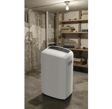 Biely odvlhčovač vzduchu v pivnici s regálmi a náradím.