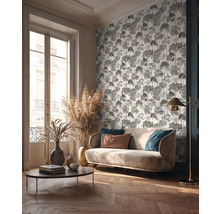 Obývacia izba s pohovkou, konferenčným stolíkom, stojacou lampou a vzorovanou tapetou