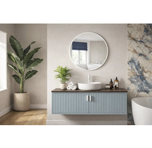 Svetlá kúpeľňa s umývadlovou skrinkou, okrúhlym zrkadlom a izbovými rastlinami.