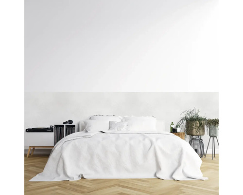 Svetlá spálňa s posteľou, gramofónom, platňami a rastlinami.