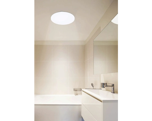 Svetlá kúpeľňa s vaňou, umývadlom a okrúhlym stropným svietidlom
