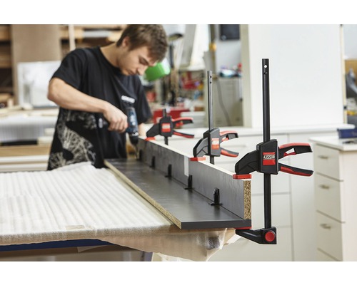 Remeselník pracuje so skrutkovacími svorkami na obrobku