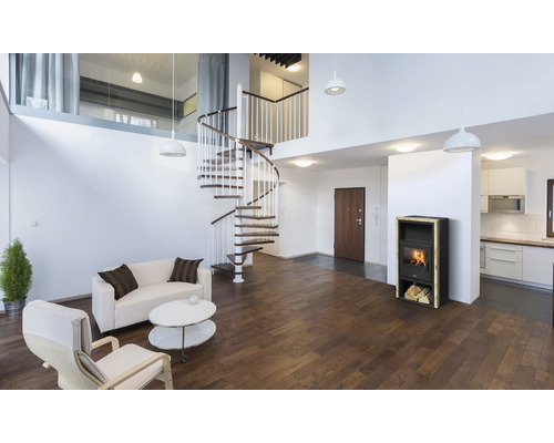 Obývacia izba so špirálovým schodiskom, kachľami, pohovkou a kreslami.